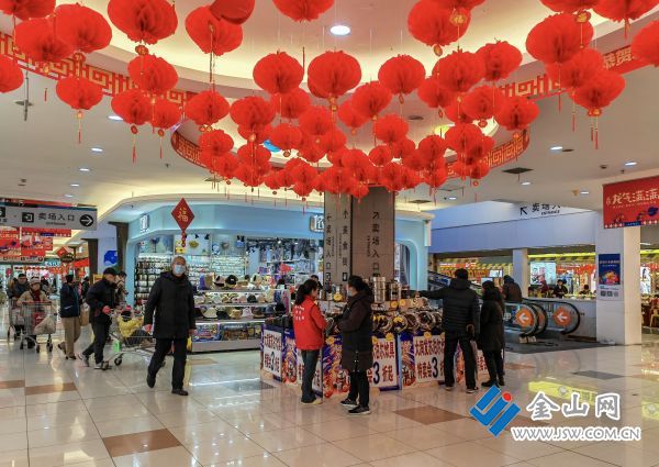 64e3f37418a7组照1，《红红火火过大年》；韩有亮；手机：13852916038。2024年2月4日拍于镇江市区一超市。年前超市掛满红灯笼，并准备了年货大街，市民纷纷走进超市购置年货。